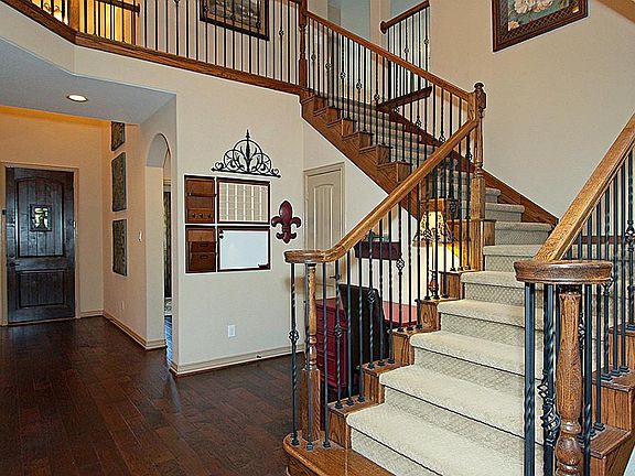 Upgraded 8 foot front Knotty Alder wood door and beautiful wood floors throughout the bottom floor.