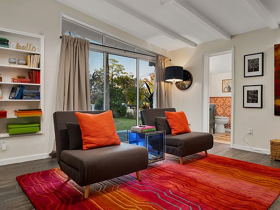 "Sunken" sitting-room with remote controlled fireplace and TV. Generous armless chairs convert into two additional single or one full size bed for guests. Patio doors lead out to fenced backyard, hot tub, and fire pit.