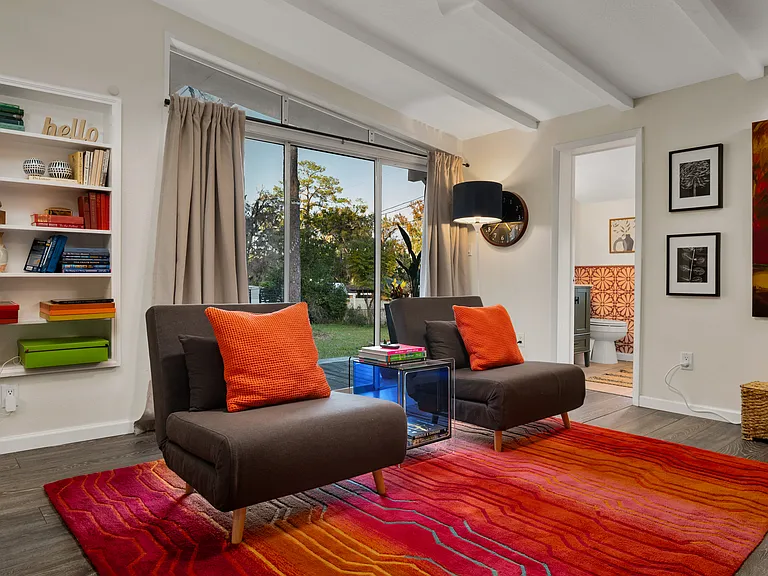 "Sunken" sitting-room with remote controlled fireplace and TV. Generous armless chairs convert into two additional single or one full size bed for guests. Patio doors lead out to fenced backyard, hot tub, and fire pit.