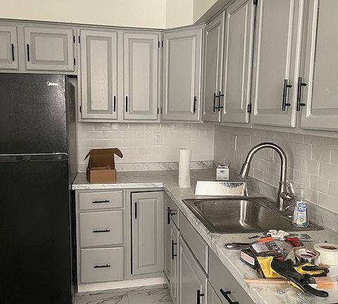 repainted kitchen cabinets with new counter top and new kitchen floors