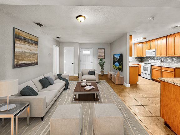 pic from back door , shotgun style living and sitting room. From this view master bedroom is on the right as well as laundry room and guest bathroom. To the left is hallway with three bedrooms, two linen closets and one full bath