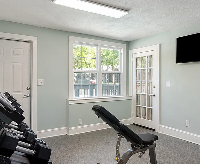 Elevate your fitness routine in this inviting home gym space, designed with your wellness in mind.