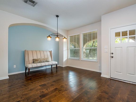 Bright and inviting entry with wood floors open to the dining space.
