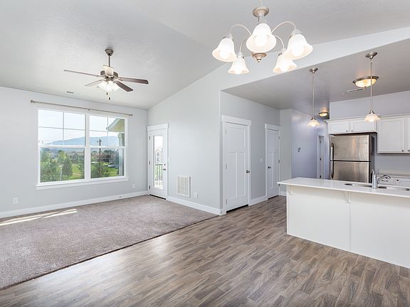 Large open-concept living area. Large pantry, balcony, and ceiling fan.