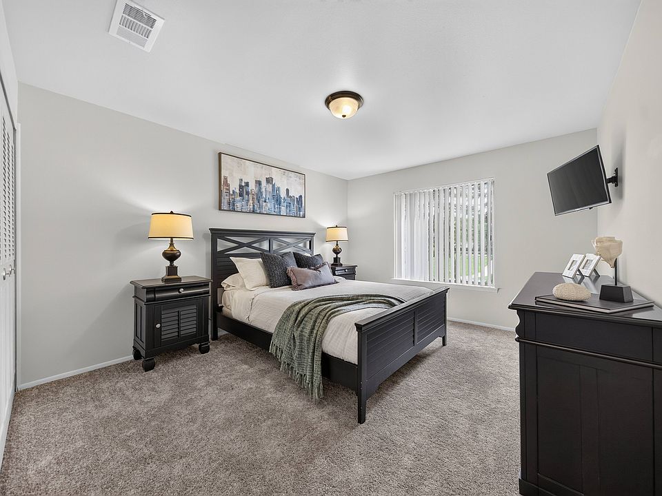 Cozy bedroom with ample storage space at Drawbridge Apartments in Harrison Township, MI.