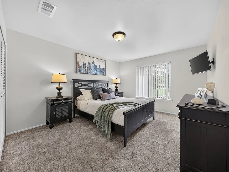 Cozy bedroom with ample storage space at Drawbridge Apartments in Harrison Township, MI.