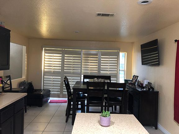 Kitchen features plantation shutters on sliding door