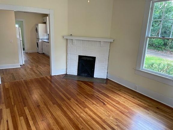 Living room looking into kitchen. Non working fireplace