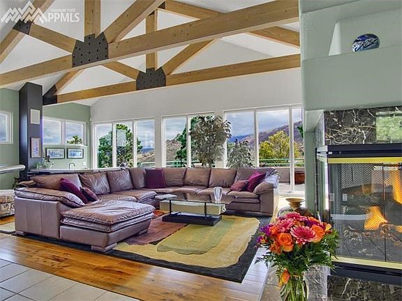 Walnut floors, gas fireplace and sunken wet bar in the far corner