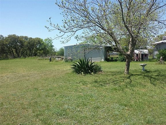 Nice 1 acre with metal barn cement flooring and roll up door with carport cover built on the barn for working or parking your car