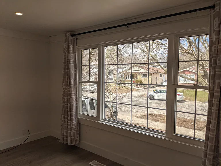 Living Room looks out onto the front street with large windows that provide tons of natural light.