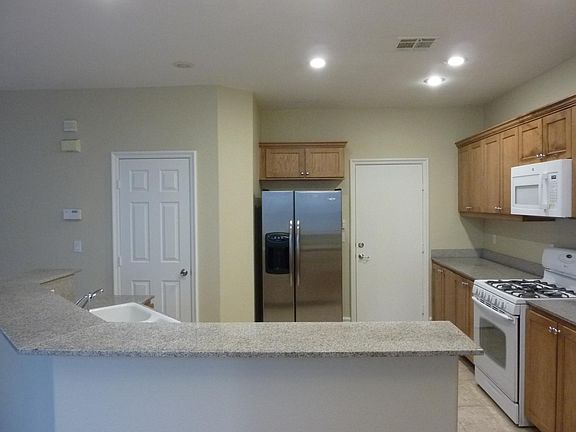 View of the kitchen with garage access. Island with breakfast bar.