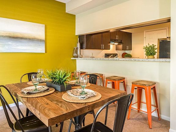 Dining area with a bar along the kitchen