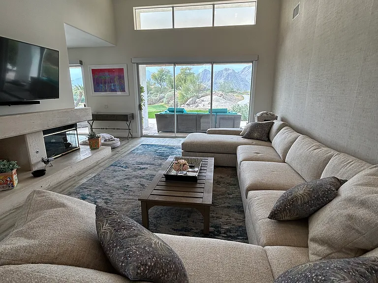 Beautifully decorated living room with extra large sectional- wide views of golf course and mountain range