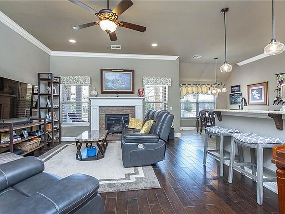 Lovely wood floors throughout. Tile in kitchen and dining room. The bar is so great for entertaining.