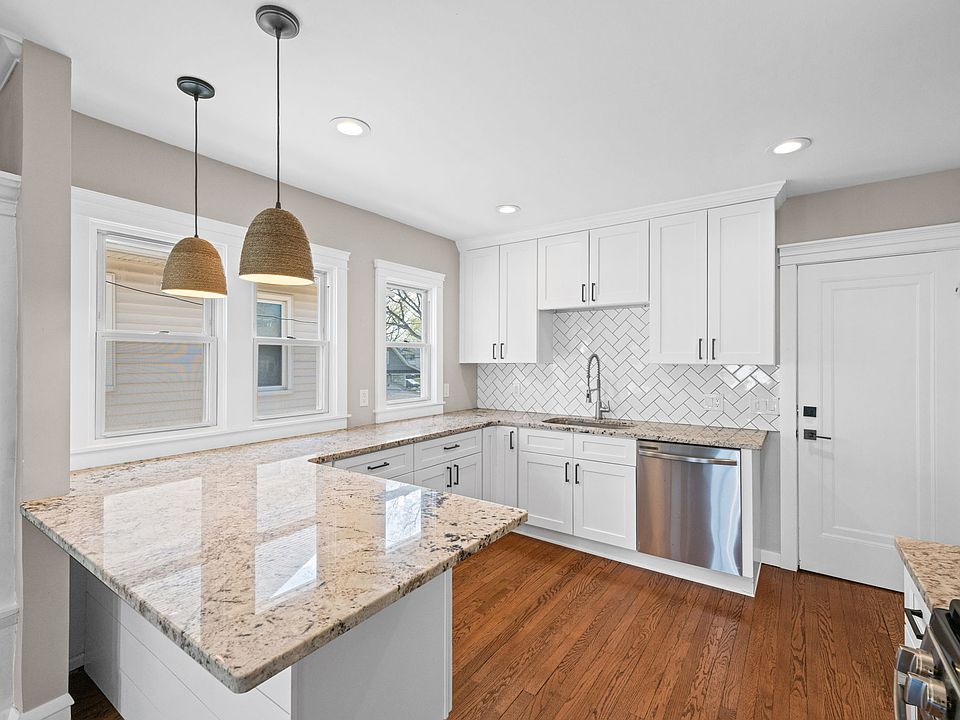 This is the updated kitchen, featuring stainless steel appliances, ample cabinets, and granite countertops.