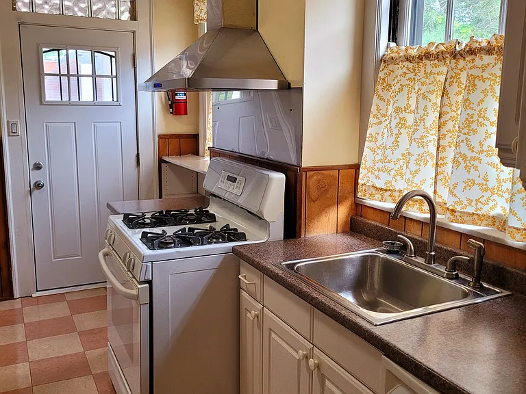 Stainless steel hood over gas stove.