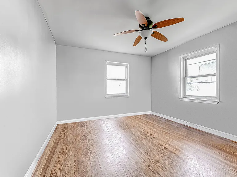 Main level 2nd bedroom shown empty, easily holds queen-size bed and desk and dresser