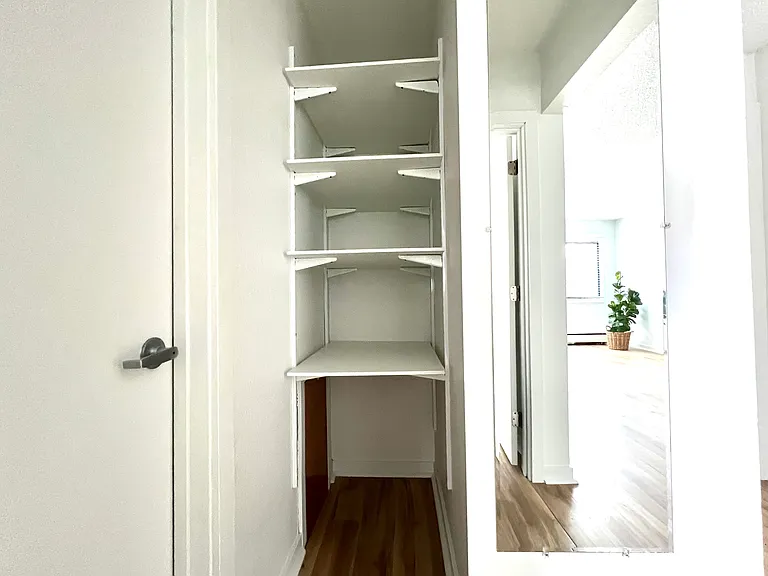 Hallway closet storage and mirror. View from hallway.