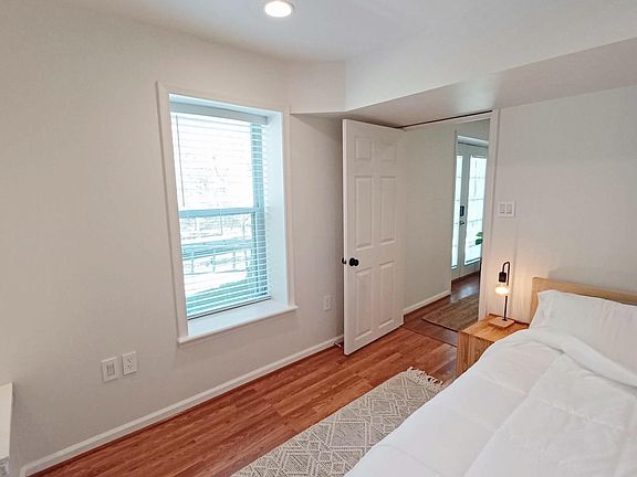 View of the bedroom with the full length windows that let in tons of natural light.