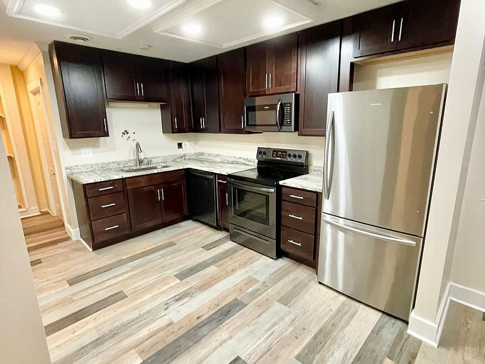 Kitchen, open concept to living room, hallway connects to laundry & storage.