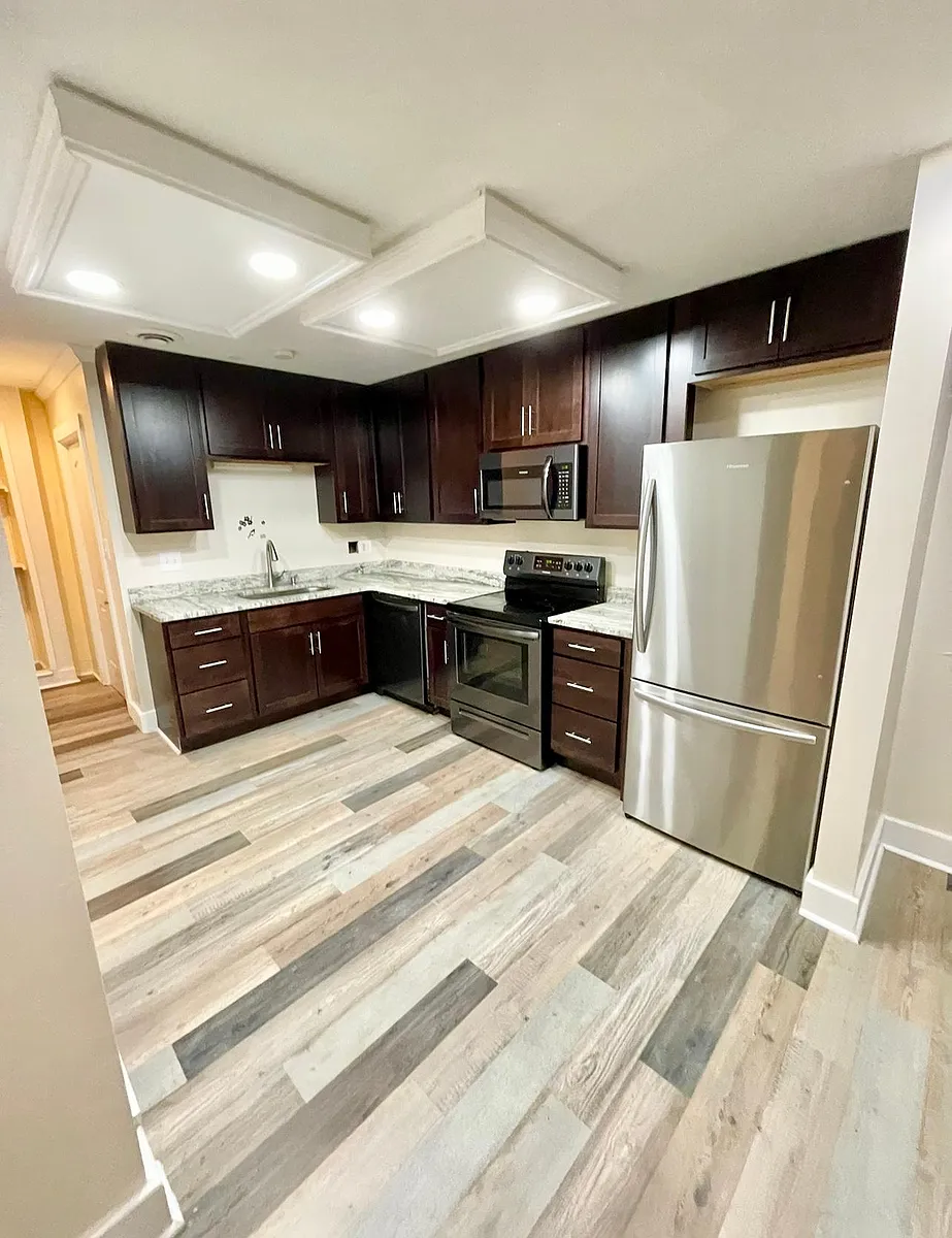 Kitchen, open concept to living room, hallway connects to laundry & storage. - 143 E Livingston Ave #A