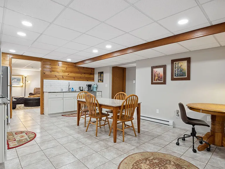 Open kitchen, furlly stocked with sliverware, dished and pots, pans.
