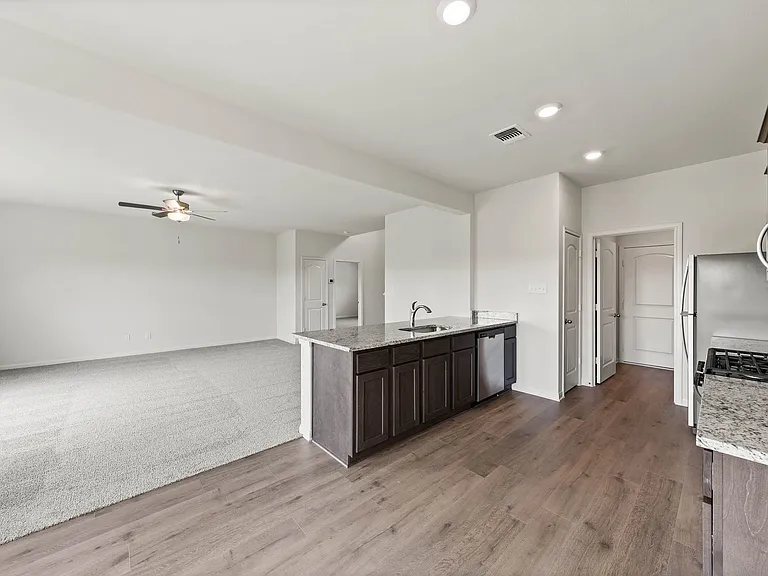 The open layout connects the kitchen with the dining room and family room.