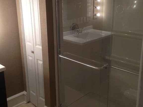 Linen closet and standing shower.