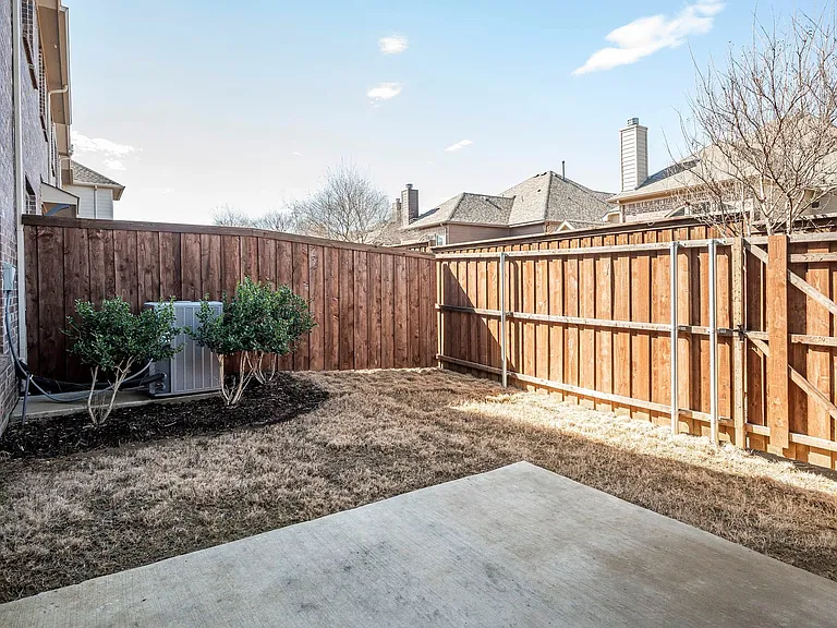 Fully fenced in backyard with an open patio to enjoy the sunshine.