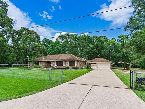 Drive in through automatic driveway gate with ample parking for cars, RV, boat