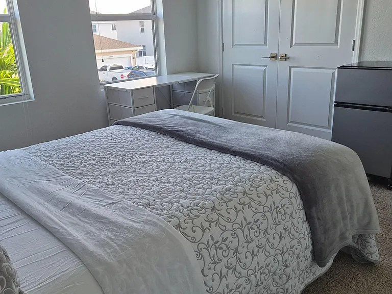 Bedroom features a bed setup, dedicated desk area, and double-door closet, with window blinds and natural light.