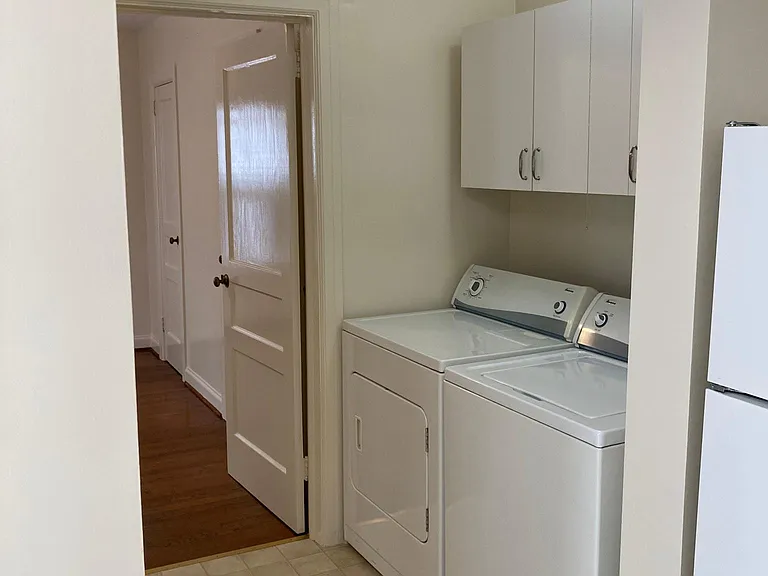 Dryer/Washer in hallway across from bathroom