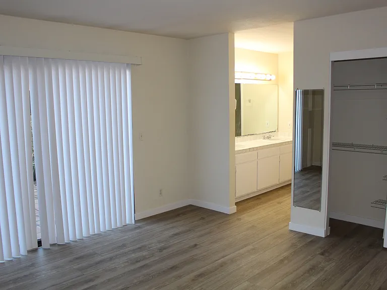 Master Bedroom with two sinks, two closets. Toilet and shower in a private room