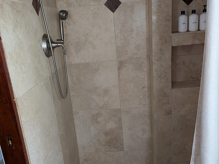 Garden level bathroom in the Suite with shower, heated tiles, closets and its own washer/dryer