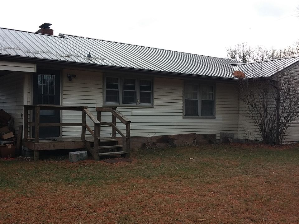 Back of house with a section of yard showing