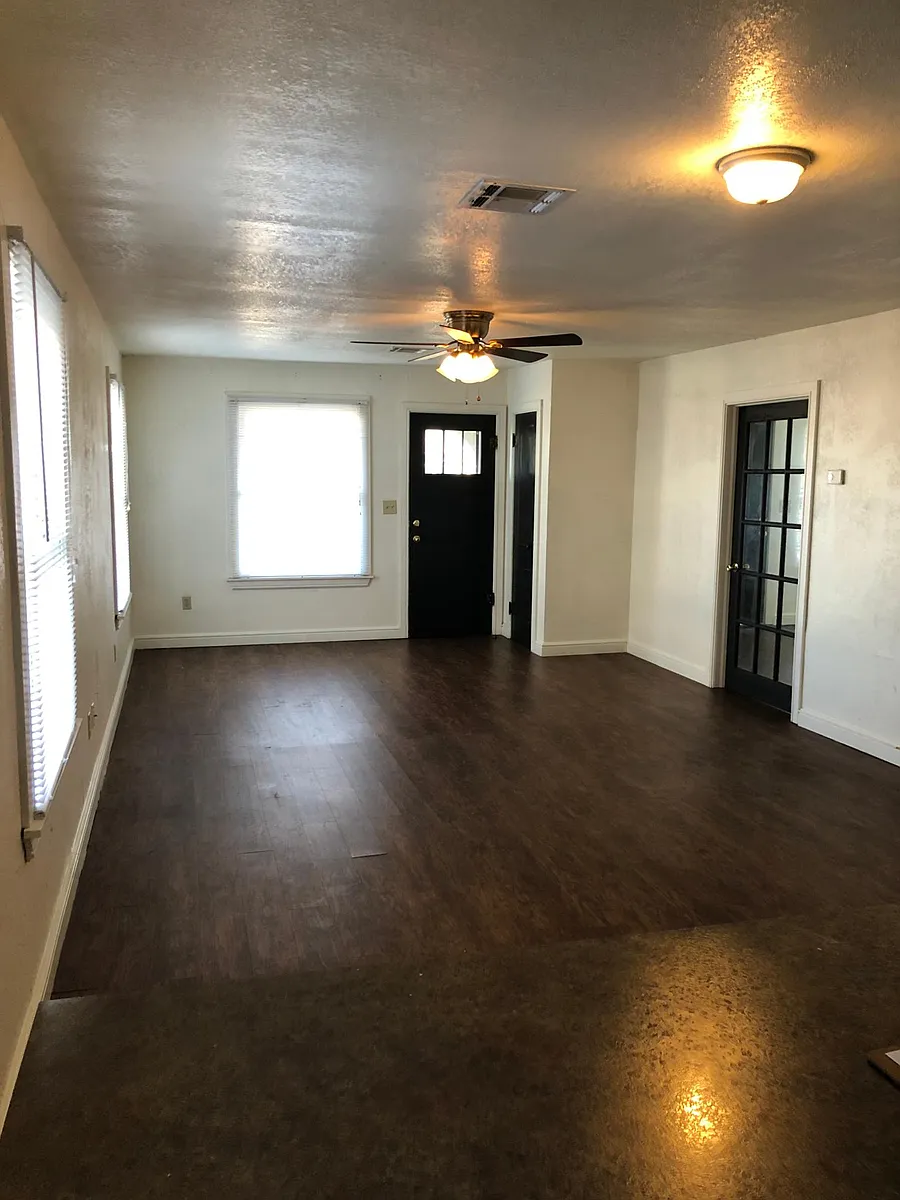 View from kitchen through living room. - 317 E Apache St