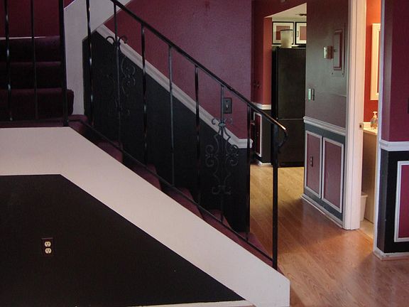 view down the hallway past the half bath and into the kitchen area