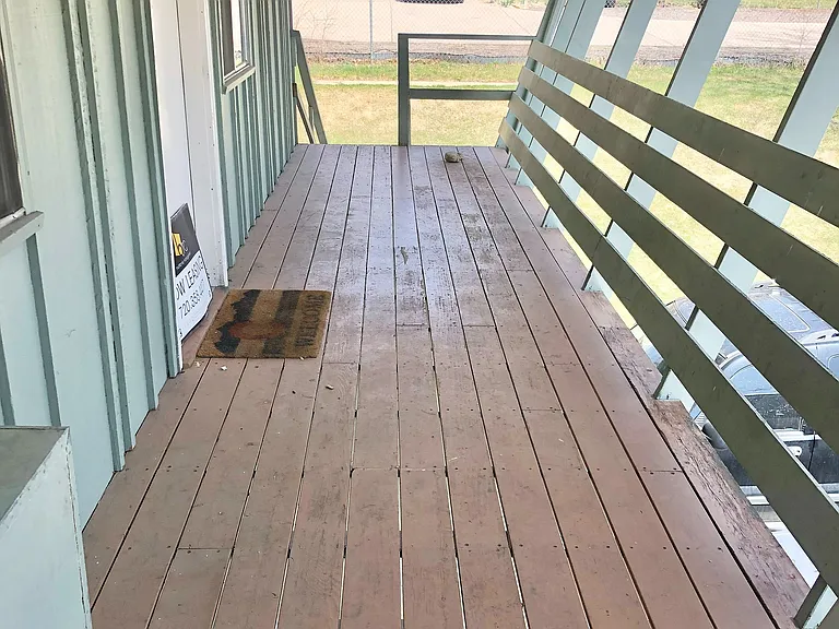 Step onto this charming porch, perfect for enjoying serene outdoor moments.