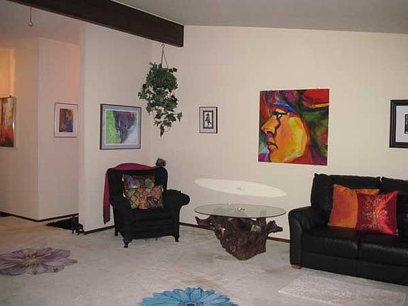 Large living room with hardwood floors under the carpet