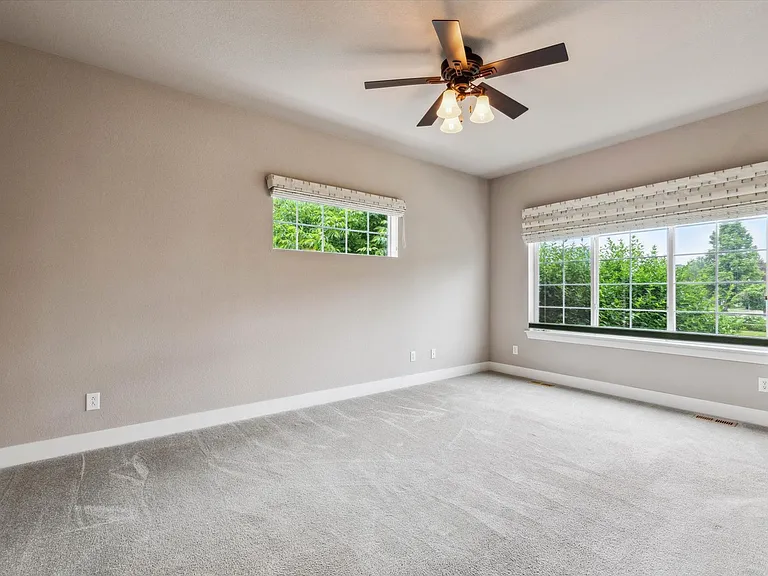 Large, main level primary bedroom with en suite bathroom and walk-in closet