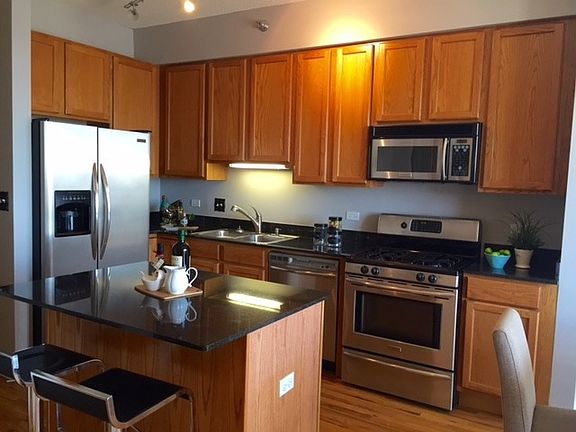 Granite countertop and stainless steel appliances in kitchen