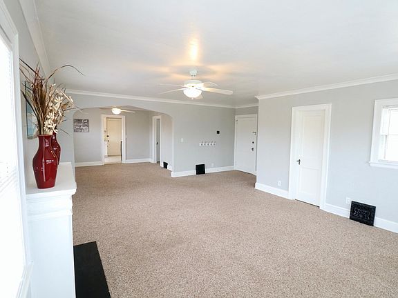 View of living room closet and front entry door