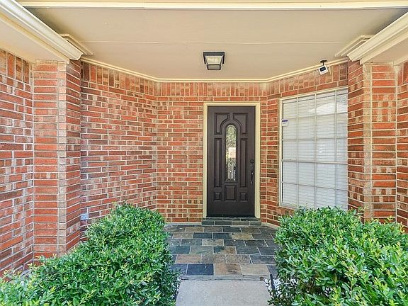 Inviting entry with recent slate patio.