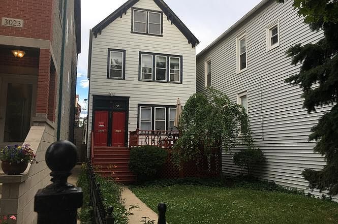 Handsome home with rare front yard on tree lined street in the heart of Lakeview.