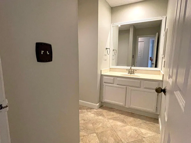 Main bathroom features a large counter with plenty of storage, a toilet, and a bathtub/shower combination with excellent water pressure.