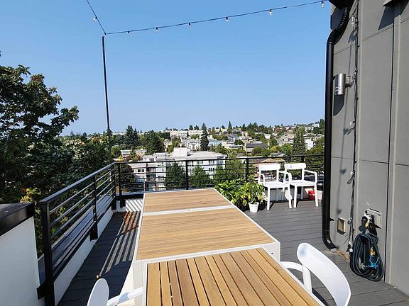 Rooftop deck with string lights, perfect for hosting and enjoying the Seattle Summer. Outdoor furniture will stay with the unit.
