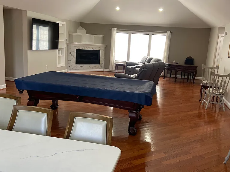 Great room, fire place, TV and desk.