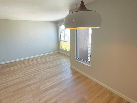 Brand new kitchen with stainless steel appliances including fridge, dishwasher, stove/over, and microwave. New quarts counters with brand new French grey cabinets. Matte black hardware and designer light design complete this open concept kitchen which ope
