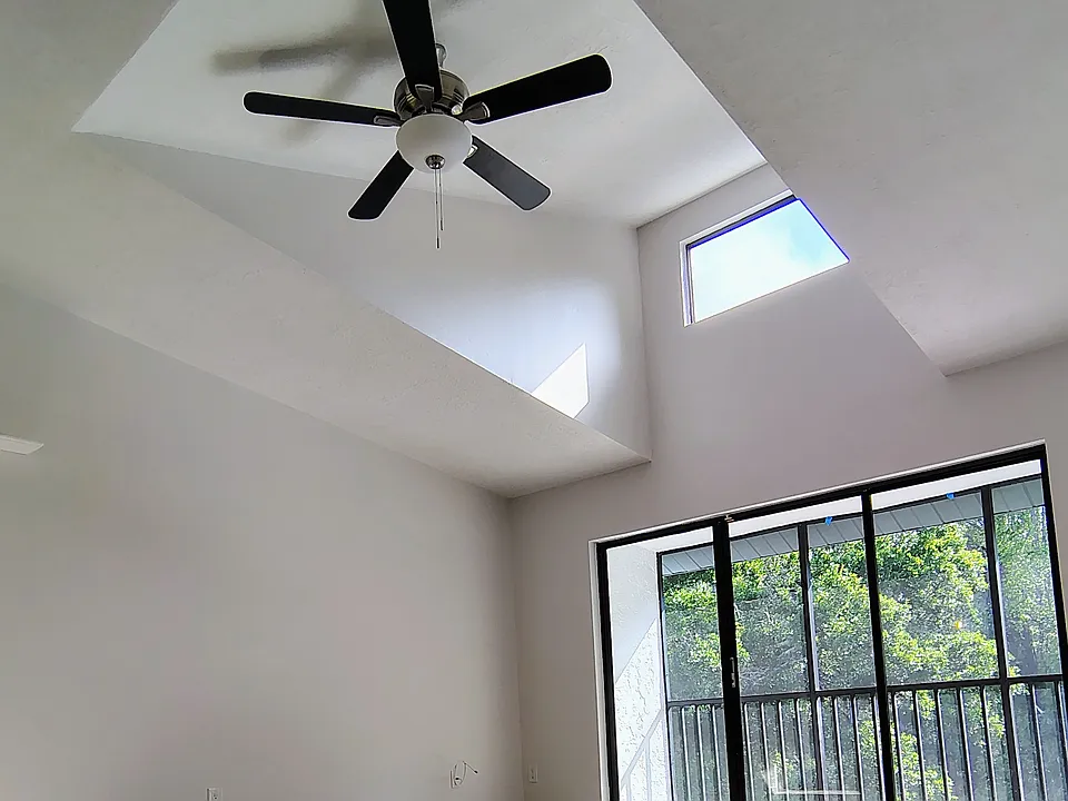 Vaulted ceiling over DR and LR w/view of balcony and preserve